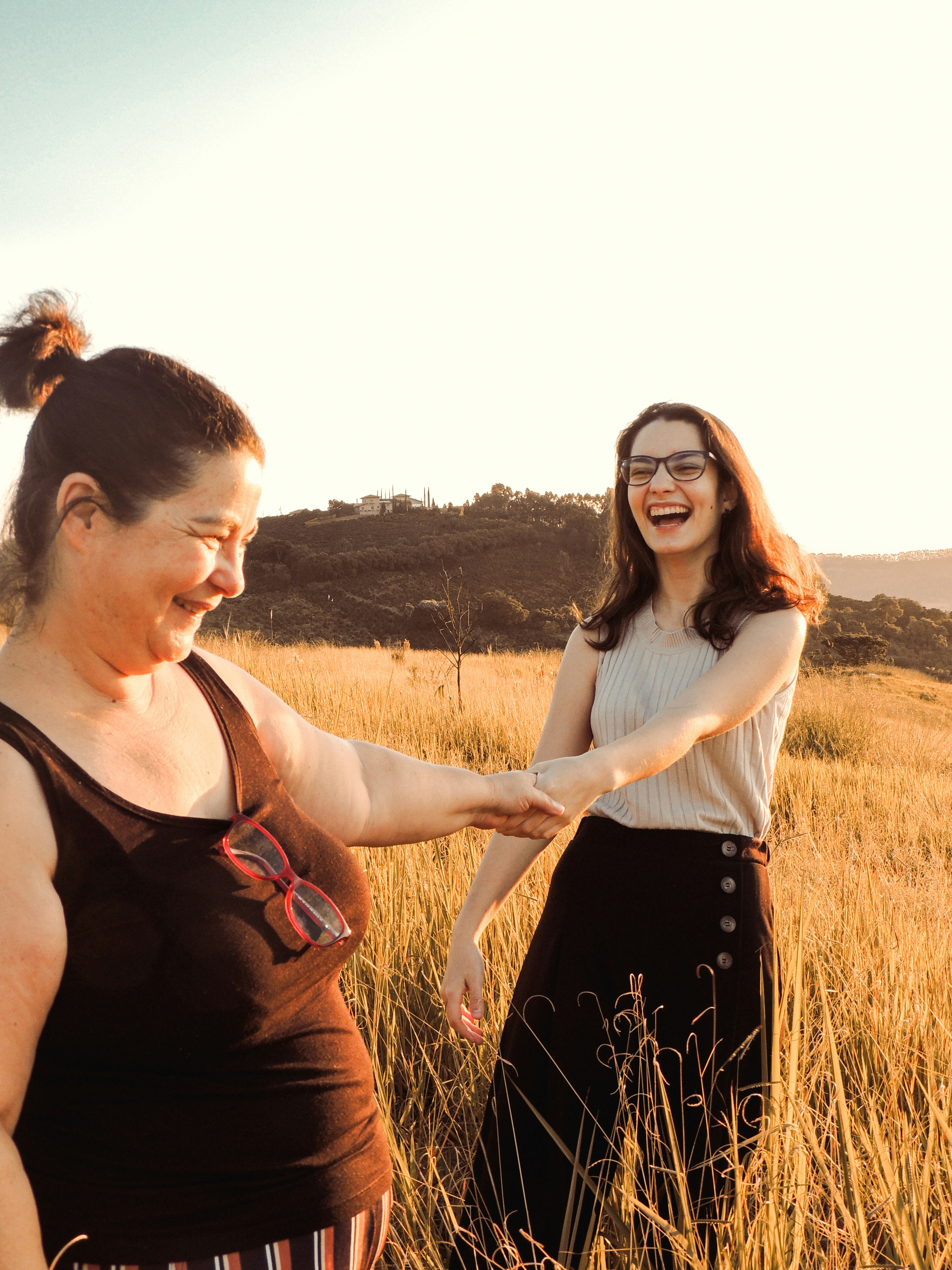 woman in black tank top holding woman in white tank top